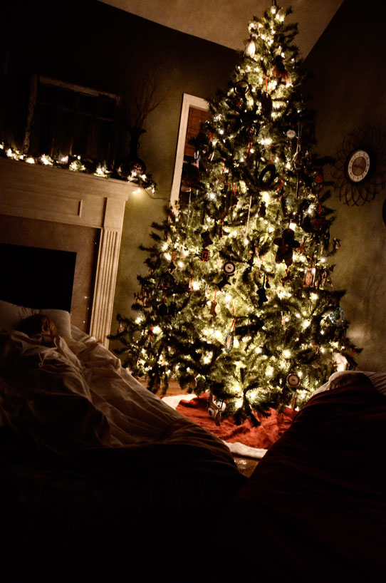 kids sleeping by Christmas tree
